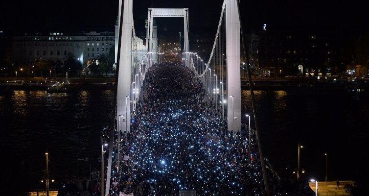 Ten-thousand participants march accross the Elisabeth bridge during an anti-government rally against the goverment's new tax plan for the introduction of the internet tax next year in Budapest on October 28, 2014. AFP PHOTO / ATTILA KISBENEDEK